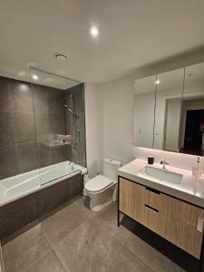 a bathroom with a sink and a toilet and a shower at Dream Apartment in Longueuil +14 photos