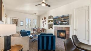 a living room with a couch and a fireplace at LV250 Upstairs 2 BDR Condo with Private Balcony in La Quinta