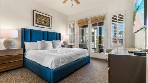 a bedroom with a blue bed and a desk at LV250 Upstairs 2 BDR Condo with Private Balcony in La Quinta +37 photos