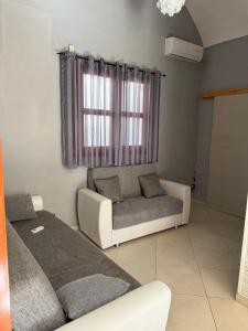 ein Wohnzimmer mit Sofa und Bett in der Unterkunft frizzi house in Parabita + 4 Fotos