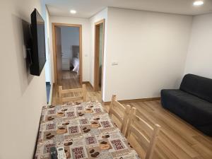 a living room with a table and a couch at Casa de baixo studios in Arouca