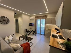 a living room with a couch and a clock on the wall at Casa Joelia in Skala