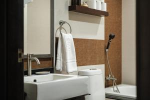 a bathroom with a sink and a toilet and a mirror at Queen Massarossa Pool Villa Pattaya-25 in Pattaya Central +22 photos