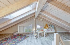 an attic room with a bed and a desk at 2 Bedroom Amazing Home In Dagebüll in Dagebüll +33 photos