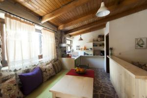 a living room with a couch and a table at Orgon Farm Village Houses in Apóstoloi