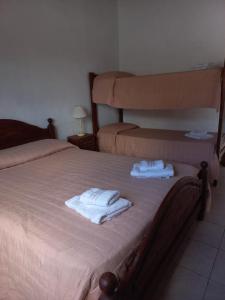 En eller flere senge i et værelse på Departamentos Stella