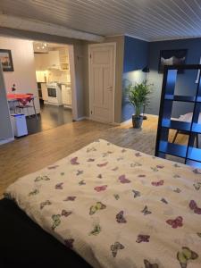 a bedroom with a bed with flowers on it at Hagestova in Volda