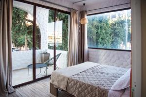 a bedroom with a bed and a large window at mandala central apartment in Rhodes Town