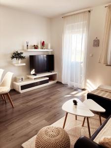 a living room with a couch and a tv at Casa Bruno in Vodnjan