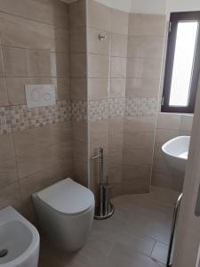 a bathroom with a toilet and a sink at Casa Vacanze Ngopp u Titl in Roseto Valfortore +16 photos