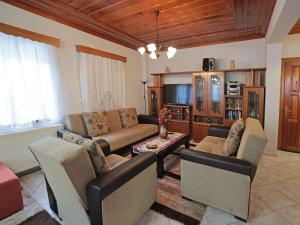a living room with a couch and a table at Stone Oasis in Tsepelovo