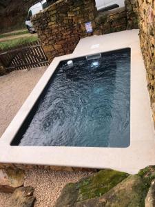 a pool of water in a stone tub at Beija Rio Charming House in Ferreira do Zêzere