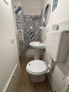 a small bathroom with a toilet and a sink at Sonalerba Ammare Trabia H H in Trabia