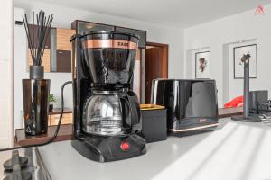 a blender sitting on a counter next to a microwave at Charm Apartment - Old Town in Bucharest
