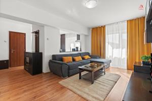 a living room with a blue couch and a table at Charm Apartment - Old Town in Bucharest