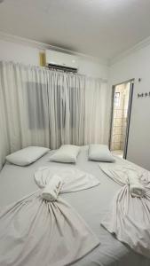 a large white bed with two pillows on it at Pousada Iracema Centro in Fortaleza