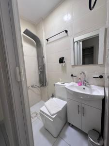 a bathroom with a toilet and a sink and a shower at Uncle Ali hotel in Wadi Musa