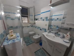 a bathroom with a shower and a sink and a toilet at A Due Passi da MicheIino in Parghelia +28 photos