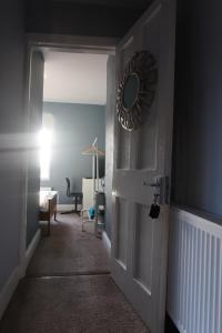 a hallway with a door with a mirror on it at Single Room in Potters Bar Hertfordshire in Potters Bar