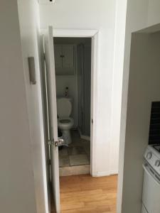 an open door to a bathroom with a toilet at Studio Manhattan Beach in Brooklyn