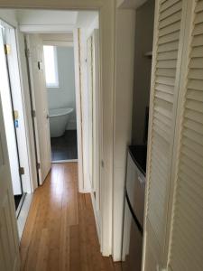 a hallway with a bathroom with a tub and a toilet at Studio Manhattan Beach in Brooklyn