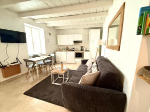 a living room with a couch and a table at Maison Arenas in Arles