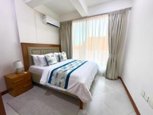 a bedroom with a bed and a window at Comfort Retreat 2 in Dar es Salaam