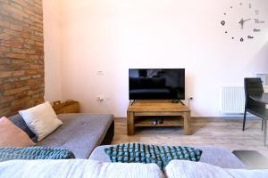a living room with a couch and a table at The Comfortable Loft in Ljubljana
