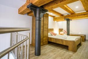 a room with two bunk beds and a staircase at The Comfortable Loft in Ljubljana