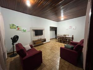 a living room with two couches and a television at Casa da Vila 3 in Cáceres