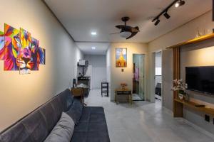 a living room with a couch and a flat screen tv at Residencial Bianca, Ap 01 - Terreo in Aracaju