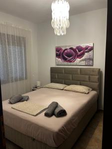 a bedroom with a large bed with two pillows on it at Veta's House in Olympiada