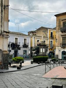an empty street in a city with buildings at La Suite da Esther in Adrano +23 photos