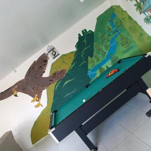 a wall mural of an eagle and a map at kaz'manou in Saint-Benoît