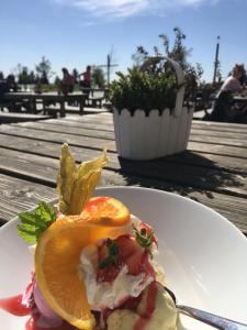 a plate of food with an orange on a table at Berg- und Seeblick in Winterberg