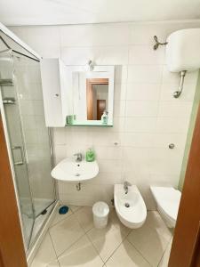 a bathroom with a sink and a toilet and a shower at Maison Intarsio in Sorrento +20 photos
