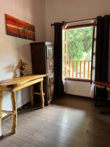 a room with a wooden bench and a window at Posada Don Porfirio in Antigua Guatemala