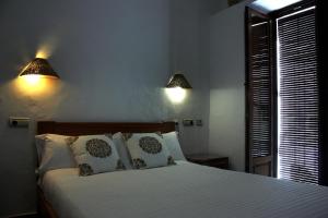Posteľ alebo postele v izbe v ubytovaní Hostal Extramuros