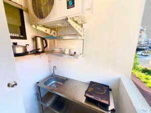 a kitchen with a sink in a small room at Patong Canal Villa 211 in Patong Beach