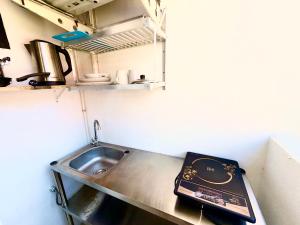 a small kitchen with a sink and a counter top at Patong Canal Villa 211 in Patong Beach +4 photos
