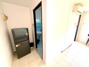 a small refrigerator in a room with a mirror at Patong Canal Villa 211 in Patong Beach