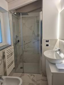 a bathroom with a shower and a sink at Riva del Lario Home Colico in Colico