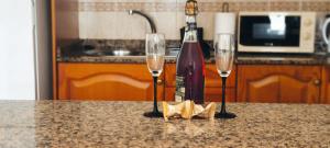 two wine glasses and a bottle of wine on a counter at Vv Maruja in Arrieta