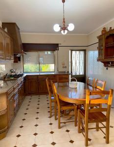 a kitchen with a wooden table and wooden chairs at Casa do Tojal in Fiscal