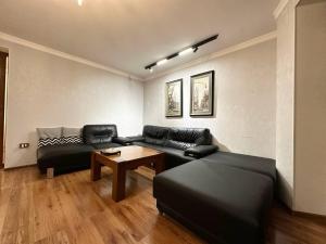 a living room with a couch and a table at Cozy Retreat in Green Dúbravka in Bratislava