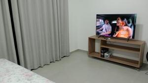 a tv sitting on a stand in a room at Studio 810 in Marília