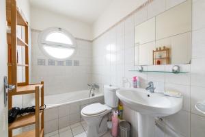 a white bathroom with a sink and a toilet at Home Up Enghien in Enghien-les-Bains