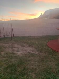 an empty field with a wall and a swing set at GR20ACD Regina in Cuauhtémoc +3 photos