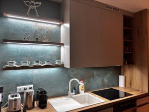 a kitchen with a sink and a counter top at 3 bathrooms Apartman Mimi in Liptovský Mikuláš +22 photos