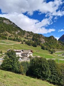 a house on a hill in a green field at Maison Neige Et Soleil in Bionaz +56 photos